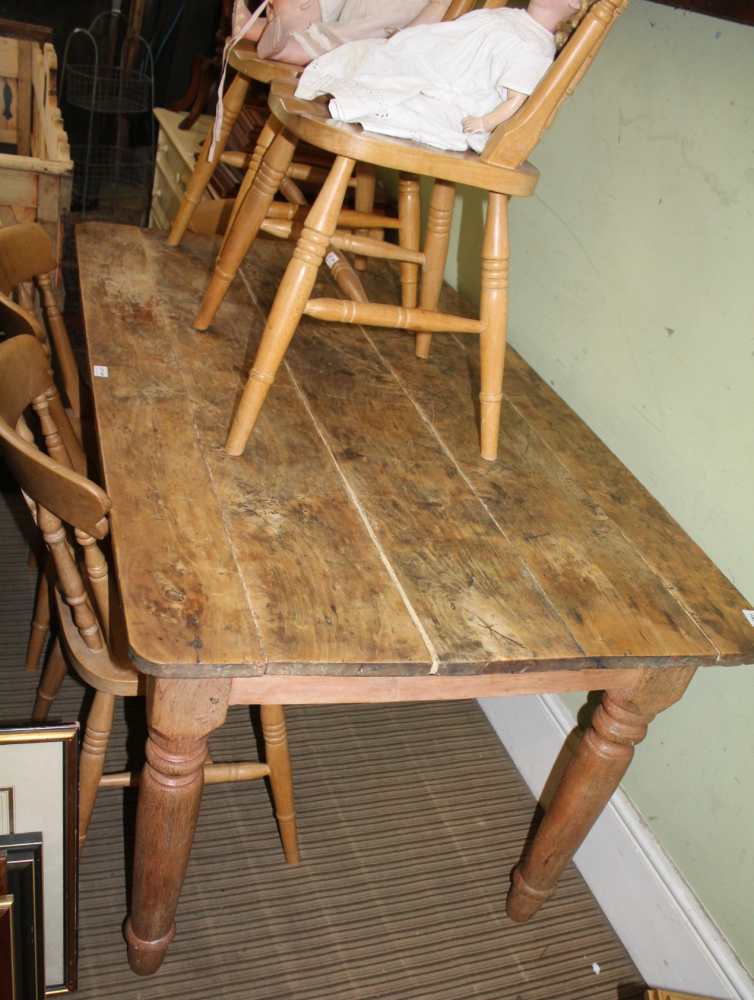 A STRIPPED WOOD PLANK RECTANGULAR TOPPED TABLE on four turned legs
