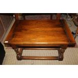 A WELL MADE REPRODUCTION OAK RECTANGULAR TOPPED COFFEE TABLE on four substantial turned and