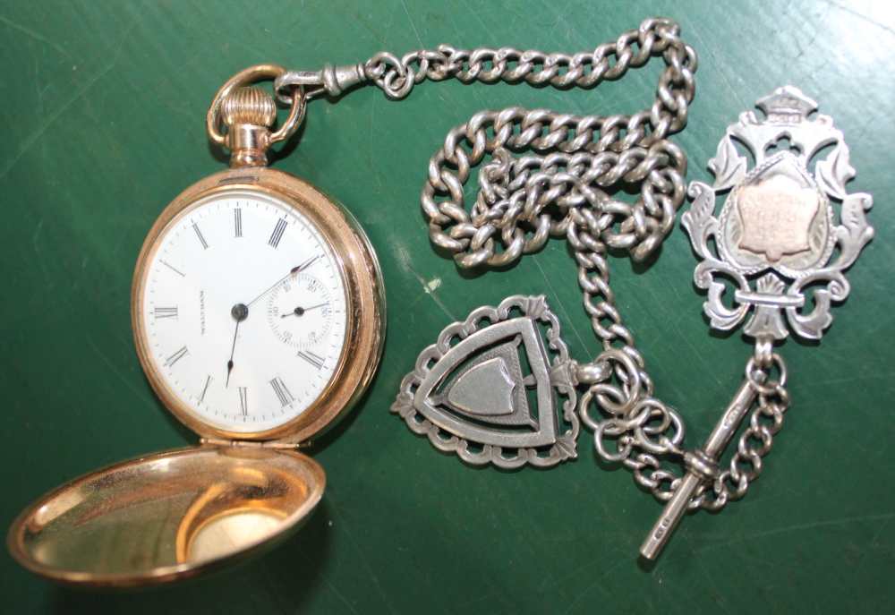 A GOLD PLATED POCKET WATCH together with a probable silver Albert with two shield fobs