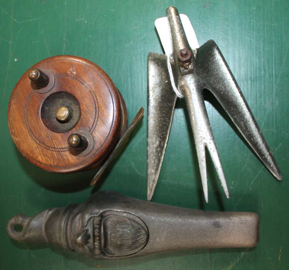 A CHROMED CAR MASCOT together with a small wooden fishing reel and a cast metal nutcracker