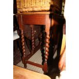 A MID OAK COLOURED LARGE TWIN FLAPPED GATELEG DINING TABLE on barley twist and block legs