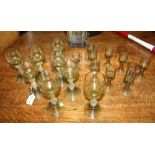 A SET OF EIGHT GREEN TINTED GLASS ROEHMERS with prunt decoration to the stems and conical bases,