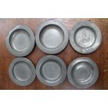A COLLECTION OF SIX SMALL PEWTER PLATES, four of them with 'London' touch marks, 10cm in diameter