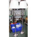 A PAIR OF MODERNIST BRUSHED SILVER FINISHED FLOOR STANDING STANDARD LAMPS