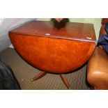 A REPRODUCTION POLLARD YEW WOOD COLOURED OVAL TWIN FLAP TOPPED TABLE