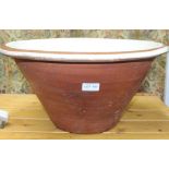 A LARGE TERRACOTTA PART GLAZED DAIRY BOWL