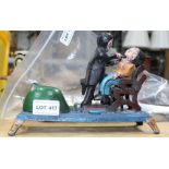 A PAINTED CAST METAL NOVELTY COIN BANK featuring a dentist pulling teeth