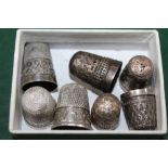 A SMALL BOX CONTAINING SILVER THIMBLES