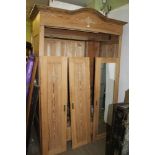 A CONTINENTAL PINE THREE DOOR WARDROBE over three shoe drawers