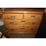 A 19TH CENTURY CONTINENTAL DESIGN PINE FOUR DRAWER CHEST with decorative sides and squashed bun feet
