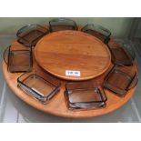 A DIGSMED TEAK LAZY SUSAN with eight smoked glass dishes