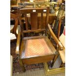 A 20TH CENTURY BEECHWOOD SLAT BACK COMODE ARMCHAIR, retaining ceramic pot