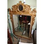 A LARGE FANCY GILT FRAMED BEVELLED PLATE WALL MIRROR