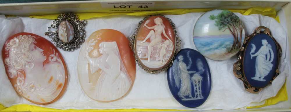 A BOX CONTAINING SIX CAMEOS and a small hand painted seascape, on a porcelain roundel