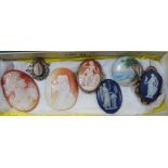 A BOX CONTAINING SIX CAMEOS and a small hand painted seascape, on a porcelain roundel