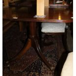 A 20TH CENTURY MAHOGANY DINING TABLE with central leaf supported on twin canon barrel columns