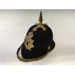 A Royal Regiment of Wales military helmet with spike and badge to front reading “The Welsh. Gwell