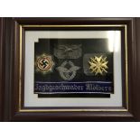 A replica German Nazi mounted and framed badge group and hat band.