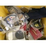 A box containing various military and service patches and badges