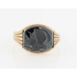 A hallmarked 9ct yellow gold hematite intaglio ring, set with a barrel shaped piece of hematite