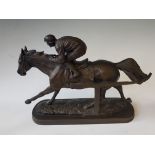 A resin figure of a horse and jockey.