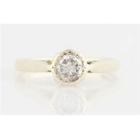 A diamond solitaire ring, bezel set with a round brilliant cut diamond, measuring approx. 0.50ct,