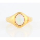 An opal single stone ring, bezel set with an oval opal cabochon, measuring approx. 7x6mm, with