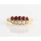 A Victorian 18ct yellow gold diamond and ruby two row ring, set with five graduated old cut