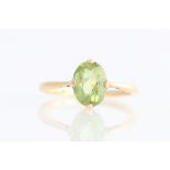 A peridot single stone ring, set with a central oval cut peridot, measuring approx. 9x7mm, stamped