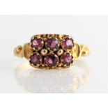 A Victorian 15ct yellow gold six stone garnet ring, set with six round cut garnets in two rows, each