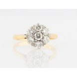 An 18ct yellow gold diamond cluster ring, set with seven round brilliant cut diamonds, total diamond
