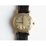 A gents 9ct yellow gold cased Visible wrist watch, the gold-tone dial having hourly Arabic numeral