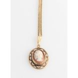 A cameo pendant in an open metalwork design frame, on a curb link chain, stamped 9k.