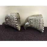 A pair of large, wall mounted, chrome finished Imperial eagle heads.
