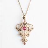 An Edwardian garnet, garnet topped doublet and seed pearl pendant, the open metalwork design set