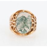 A hallmarked 9ct yellow gold moss agate ring, set with an oval moss agate cabochon, measuring