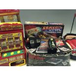 A selection of various toys including atomic pinball, super slot triple thunder mini fruit