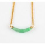 A green jade necklace, comprising a curved piece of carved jade attached to a belcher link chain,