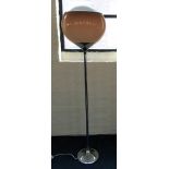 A modern chrome floor standing light fitting with brown shade.