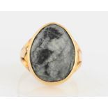 A cabochon set ring, set with a grey/black stone pear shaped cabochon, with split design