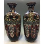 A pair of oriental style cloisonné vases, with multi colour dragon, bird and floral design,