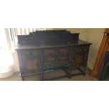 An oak four drawer and two door sideboard.