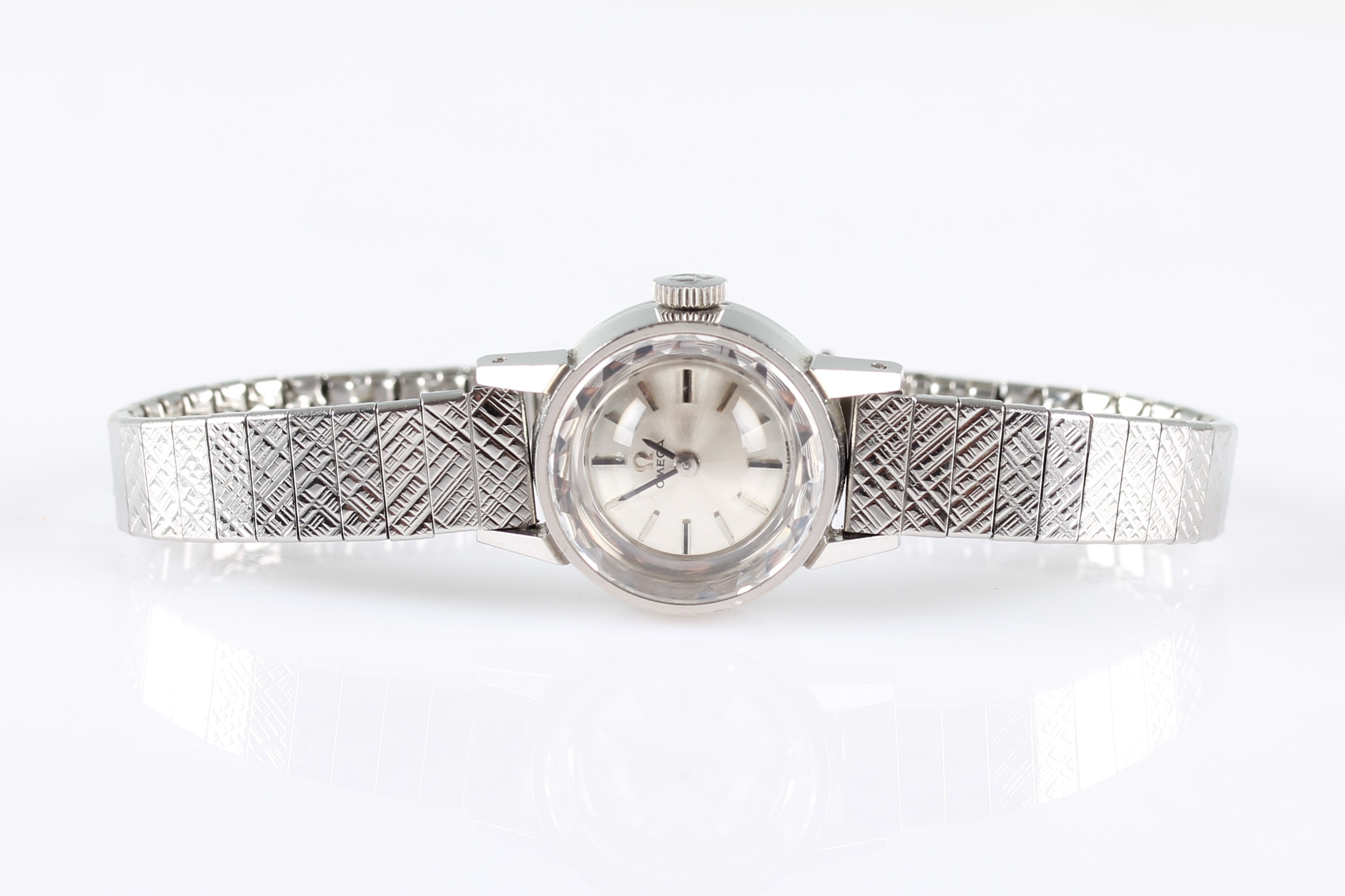 A stainless steel ladies Omega wrist watch, the silver-tone dial having hourly baton markers, on a