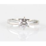 A hallmarked platinum diamond solitaire ring, set with a round brilliant cut diamond, measuring