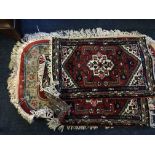 Five various rugs, three red, one Chinese style and one brown patterned rug.