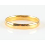 A hallmarked 22ct yellow gold plain wedding band.