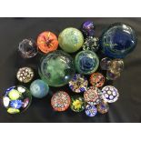 A selection of eighteen glass paperweights, to include various millefiori designs, one Victorian