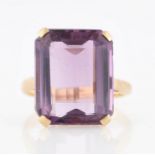 An amethyst dress ring, set with an emerald cut amethyst, measuring approx. 13x15mm, stamped 9ct,