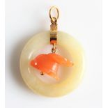 A yellow/green jade and orange hardstone pendant, designed as the yellow/green jade circle