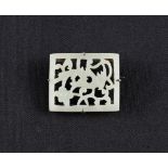 A white Oriental hardstone brooch, the rectangular form featuring carved bird and floral design,